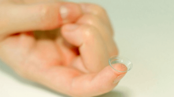 NuVision Biotherapies- hand holding a contact lens